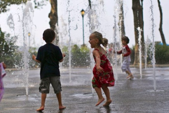 Children play in a fountain to cool off at New York City's Battery Park in lower Manhattan, July 21, 2011.