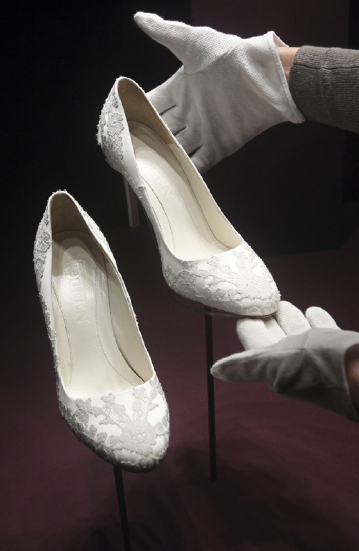 The bridal shoes of Britain's Catherine, Duchess of Cambridge are seen as they are prepared for display at Buckingham Palace in London July 20, 2011. Buckingham Palace expects record crowds this summer as up to 650,000 people are set to file into Queen Elizabeth's London residence and past the dress worn by Kate Middleton at her royal wedding to Prince William. The ivory and white garment, designed by Sarah Burton for Alexander McQueen, won over the fashion press and public when Middleton, now the Duchess of Cambridge and a future queen, walked up the aisle of Westminster Abbey in April. Picture taken July 20, 2011.