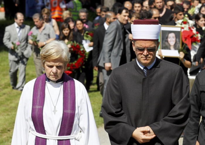 Christian cleric Anne Marie Tronvik (L) and Senaid Kobilica (R), chairman of the Islamic Council of Norway, lead the funeral ceremony of Bano Rashid, 18, at Nesodden church near Oslo July 29, 2011, as the nation pauses for memorial services after the worst attacks on the nation since World War Two. Norway is holding the first funeral on Friday for a victim of Anders Behring Breivik's massacre of 76 people a week ago amid signs of a leap in popularity for the ruling Labour Party that was his main target. Flags around the nation flew at half mast to mark a day of memorial one week after Breivik, an anti-Islam zealot, set off a bomb in central Oslo that killed 8 people. He then shot 68 people at a summer camp for youths of the ruling Labour Party.