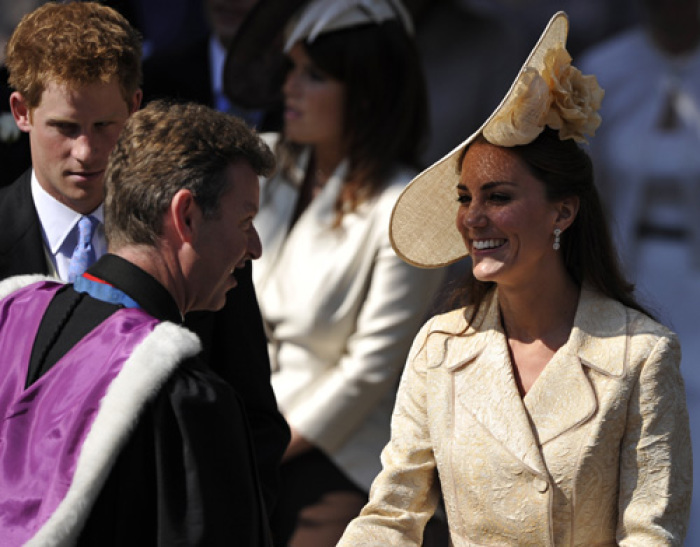 Catherine, Duchess of Cambridge, chats with Reverend Neil Gardner as Prince Harry looks on after the marriage of Britain's Zara Phillips, the eldest granddaughter of Queen Elizabeth, and England rugby captain Mike Tindall, at Canongate Kirk in Edinburgh, Scotland July 30, 2011.