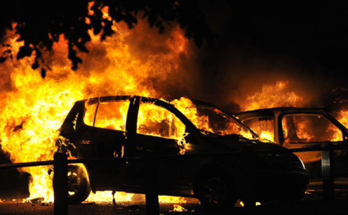 Cars burn on a street in Ealing, London August 9, 2011. Looting by groups of hooded youths spread to Ealing in west London and Camden in the north of the British capital late on Monday, the third night of violence which police have blamed on criminal thugs.