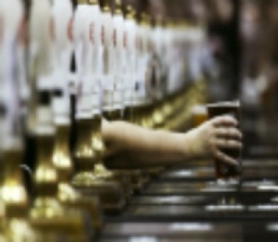 A pint of beer is served through rows of beer pumps in this file photo from August 2, 2011. British pubs.