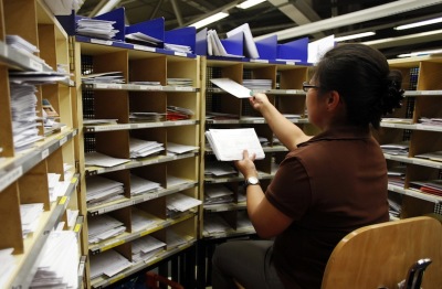 An Austrian Post employee sorts letters in the main post letter logistic hub in Vienna, November 15, 2010. The Austrian Post letter logistic centre in Vienna handles an average of 4.2 million letters a day and rises up to about 9 million letters during Christmas time.