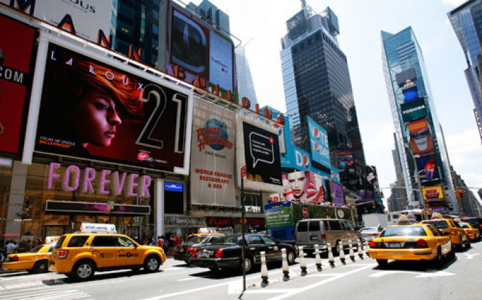 Vehicles pass the Forever 21 flagship store in New York's Times Square during its grand opening June 25, 2010. The 91,257 square feet megastore makes Forever 21's Times Square location the largest single brand apparel store in Manhattan.