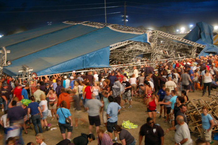 Concertgoers and emergency personnel hold up the stage roof and rigging after it collapsed minutes before a concert by Sugarland at the Indiana State Fairgrounds in Indianapolis August 13, 2011. Four people were killed and at least 40 people were hurt when the stage collapsed in windy weather at the fair on Saturday, just minutes before country music duo Sugarland was set to perform.