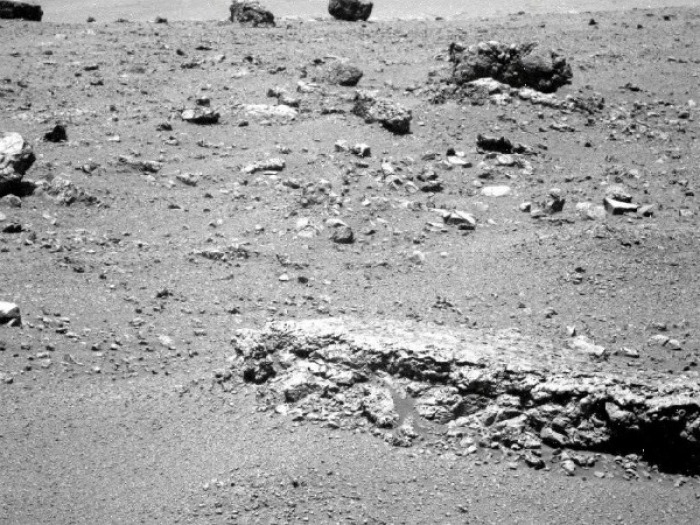 The flat-topped rock just below the center of this raw image from the rover Opportunity's panoramic camera was chosen by the rover team in August 2011 as a stop for inspecting with tools on Opportunity's robotic arm. This image was taken during the 2,688th Martian day, or sol, of Opportunity's work on Mars (Aug. 16, 2011), which was seven days after the rover arrived at the western rim of Endeavour Crater.