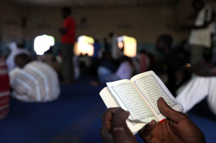 A man reads the quran at Mosque during Friday prayers in Makina Mosque in Nairobis's Kibera slums August 5, 2011.