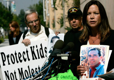 Survivors Network of those Abused by Priests (SNAP) Southwest Regional Director Mary Grant (R) speaks at a news conference commenting on the release of the Roman Catholic Archdiocese of Los Angeles documents on priests accused in sex abuse cases at the Cathedral of Our Lady of the Angels in Los Angeles October 12, 2005. The documents reveal that Church officials moved accused priests between counseling and new assignments for decades.