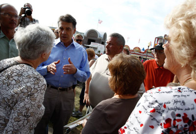 U.S. Republican presidential candidate Texas Governor Rick Perry speaks to people at the Iowa State Fair in Des Moines, Iowa, August 15, 2011.