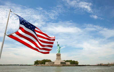 A U.S. flag waves in the wind on a boat near the Statue of Liberty in New York August 31, 2011.