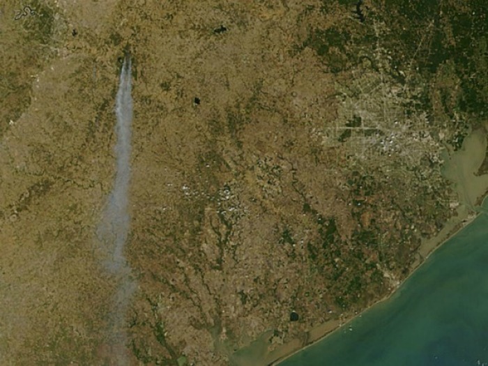 Smoke flows from Bastrop County in central Texas south to the Gulf Coast. Houston is seen on the east side in this satellite picture released by NASA of the Texas wildfires.
