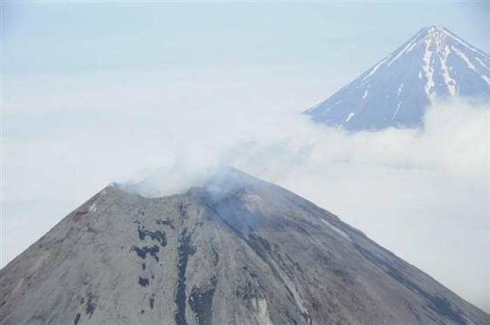 Cleveland Volcano, a 5,676 foot-tall (1,730 meters) peak located about 940 miles (1,500 km) southwest of Anchorage, emits light steam in this Aug. 8 view provided by the National Oceanic and Atmospheric Administration. The volcano has been in low-level eruption since the end of July, the Alaska Volcano Observatory said.