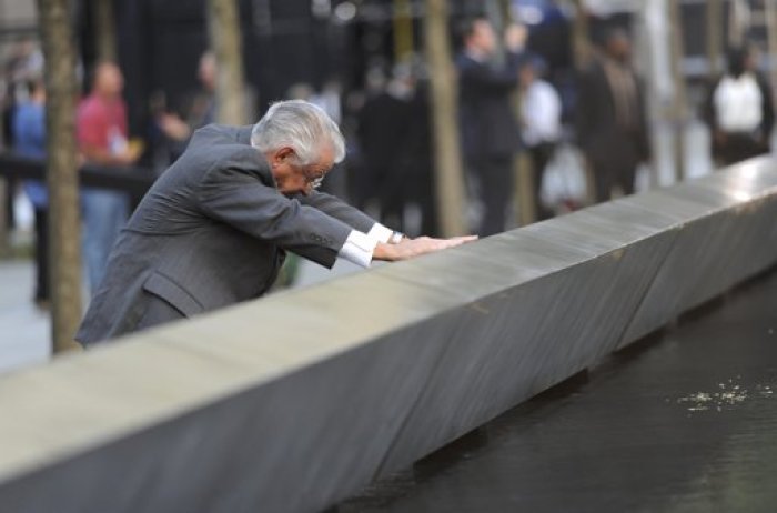 Robert Peraza finds the name of his son, Robert David Peraza, who died in the 9/11 attacks on New York, on a memorial wall prior to ceremonies at the site of the World Trade Center in New York, September 11, 2011.