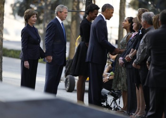 U.S. President Barack Obama speaks with victims' relatives as he visits the north pool of the World Trade Center site with first lady Michelle Obama, former President George W. Bush and former first lady Laura Bush (L) during ceremonies marking the 10th anniversary of the 9/11 attacks on the World Trade Center, in New York September 11, 2011.