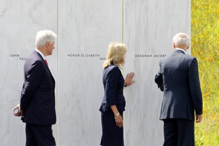 Dr. Jill Biden and U.S. Vice President Joe Biden (R) touch the Flight 93 National Memorial name of Deborah Jacobs, as former U.S. president Bill Clinton (L) watches, during ceremonies marking the 10th anniversary of the 9/11 attack conclude, in Shanksville, Pennsylvania September 10, 2011.
