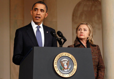 U.S. President Barack Obama (L) speaks about Libya while Secretary of State Hillary Clinton listens in the White House in Washington February 23, 2011.