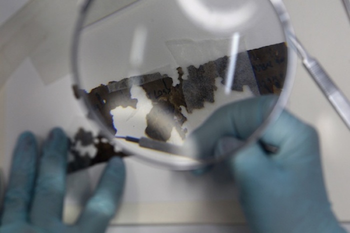 A preservationist works on a fragment of the Dead Sea Scrolls in a laboratory in the Israel Museum in Jerusalem October 18, 2010. Israel Antiquities Authority,the custodian of the scrolls that shed light on the life of Jews and early Christians at the time of Jesus, say it was collaborating with Google's research and development centre in Israel to upload digitized images of the entire collection.