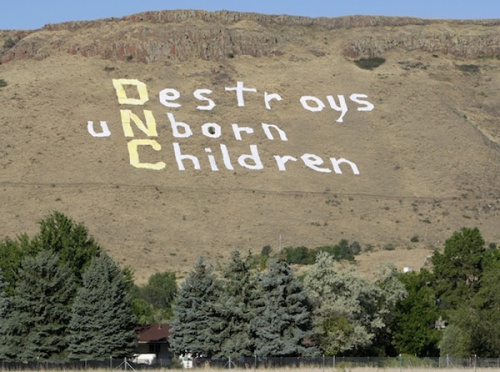 Credit : Anti-abortion demonstrators unfurl a giant sign on the side of North Table Mountain in Golden, Colo., in this Aug. 26, 2008 file photo.