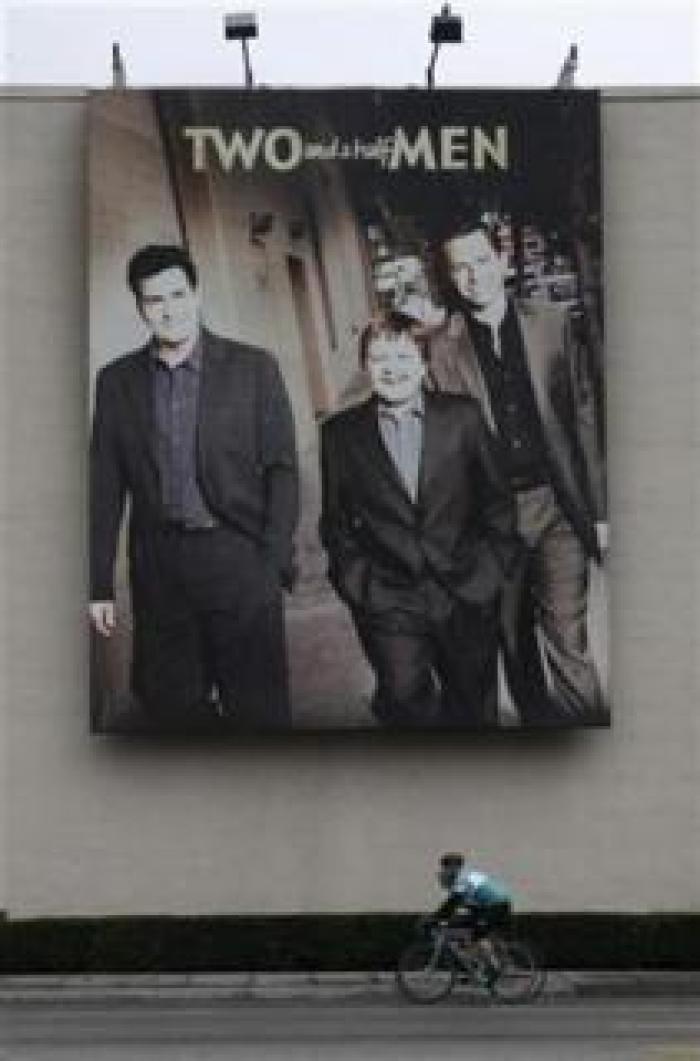 A poster promoting actor Charlie Sheen's hit comedy series 'Two and A Half Men' is shown at Warner Bros. Studios in Burbank, California January 30, 2011.