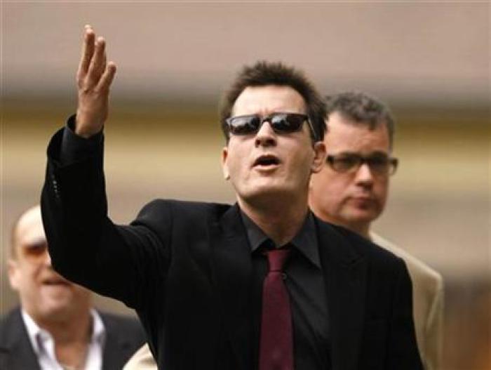 Actor Charlie Sheen gestures towards fans as he arrives for a sentencing hearing at the Pitkin County Courthouse in Aspen, Colorado August 2, 2010.