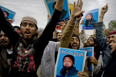 Supporters of various religious parties hold images of Malik Mumtaz Hussain Qadri and chant slogans in support of Qadri, the gunman detained for the killing of Punjab Governor Salman Taseer. The murder of the politician who opposed the country's anti-blasphemy laws, a case that exposed deep fissures in Pakistani society. The Urdu on the images read: 'We salute your courage'.