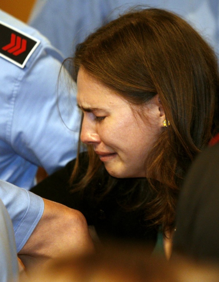 U.S. student Amanda Knox reacts after hearing the verdict during her appeal trial session in Perugia October 3, 2011. An Italian court cleared 24-year-old Knox and her former boyfriend of murdering British student Meredith Kercher in 2007 and ordered them to be set free on Monday after nearly four years in prison for a crime they always denied committing. Seattle native Knox and Italian computer student Raffaele Sollecito, had appealed against a 2009 verdict that found them guilty of murdering 21-year-old Kercher during what prosecutors said was a drug-fuelled sexual assault four years ago.