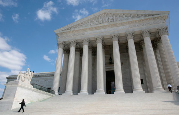 Security guards walk the steps of the Supreme Court in Washington, October 1, 2010.