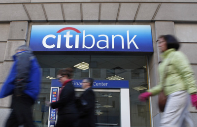 Pedestrians walk past a Citibank branch in Washington DC.