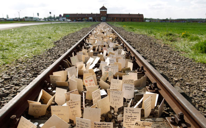 Jews from all over the world place small placards in front of the main railway building at the former Nazi death camp of Birkenau (Auschwitz II) in Oswiecim, southern Poland, May 2, 2011. Thousands of mainly Jewish people participated in the 17th annual 'March of the Living,' a Holocaust commemoration.