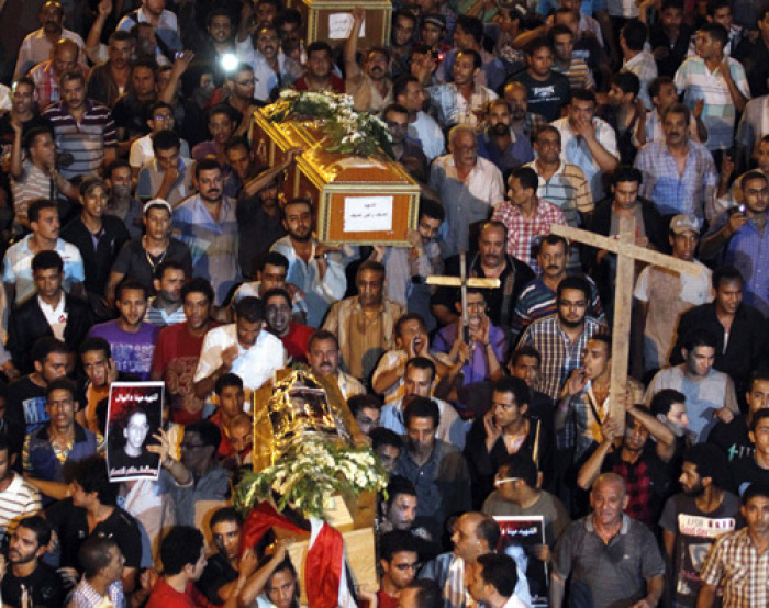 Egyptian Coptic Christians carry coffins as they make their way to Abassaiya Cathedral during a mass funeral for victims of sectarian clashes with soldiers and riot police, after a protest about an attack on a church in southern Egypt, in Cairo October 10, 2011. Egypt's Coptic Christians turned their fury against the army on Monday after at least 25 people were killed when troops broke up a protest, deepening public doubts about the military's ability to steer the country peacefully towards democracy.