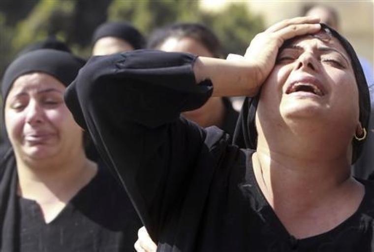 Egyptian women grieve before a mass funeral for Coptic Christians killed in sectarian clashes with soldiers and police at a protest against an attack on a church in southern Egypt at Abassaiya Cathedral in Cairo, Oct. 10, 2011.