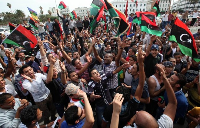 Residents celebrate at Martyrs square in Tripoli October 20, 2011 after hearing the news that former leader Muammar Gaddafi was killed in Sirte. Gaddafi died in an attack by NTC fighters, a senior NTC official said on Thursday.