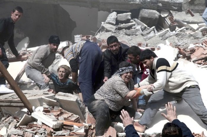 Rescue workers try to save people trapped under debris after an earthquake in a village near the eastern Turkish city of Van on Oct. 23, 2011.