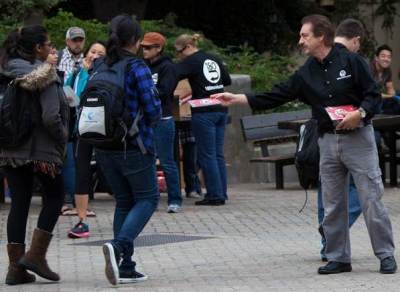 Evangelist Ray Comfort, who produced the pro-life film “180,” passes out DVD copies of the 33-minute video at UCLA, Oct. 25, 2011.