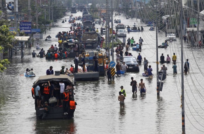 People are evacuated on trucks from a flooded area in Bangkok's suburbs