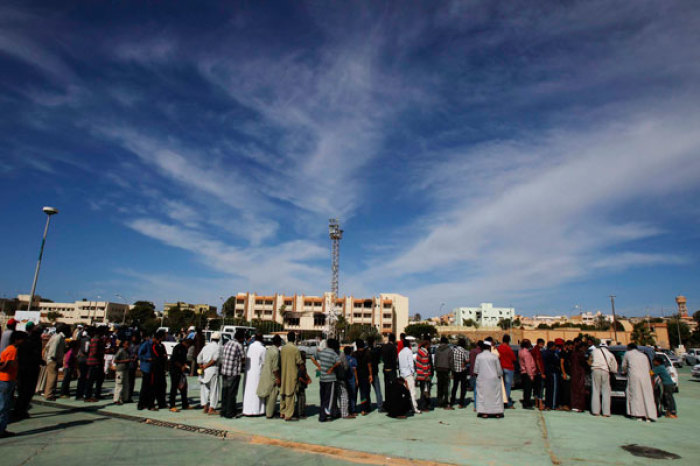 Civilians in Sirte queue to receive food and daily rations donated from various cities in Libya, November 3, 2011.