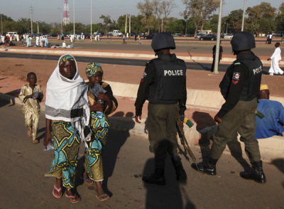 Nigerian police patrol in the capital Abuja, on Nov. 6, 2011. At least 65 people were killed in the northeast Nigerian city of Damaturu, an aid agency said on Saturday, after Islamist insurgents bombed churches, mosques and police stations and fought hours of gun battles with police.