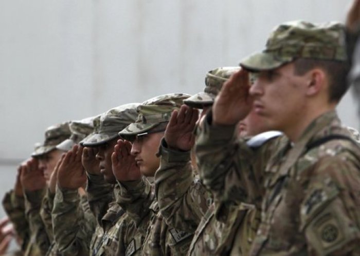 U.S. soldiers salute at ceremony celebrating Veterans Day at the Bagram airfield, north of Kabul November 11, 2011.