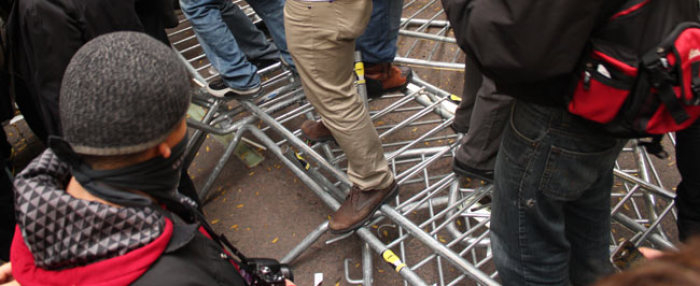 Protesters stomp on police barricades in Zuccotti Park in an 'Occupy Wall Street' rally Nov. 17, 2011.