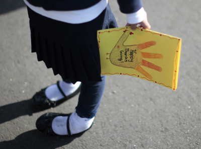 A school girl holds a Thanksgiving card in Los Angeles, California November 23, 2011.