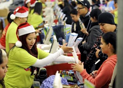 Shoppers pay for their purchases at an Old Navy store as Black Friday shoppers get an early start at the Citadel outlet stores on Thanksgiving in Los Angeles, Calif., on Nov. 25, 2011.