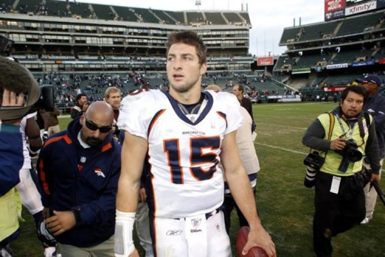 Denver Broncos' quarterback Tim Tebow walks off the field after Broncos defeated the Oakland Raiders in their NFL football game in Oakland, California November 6, 2011.