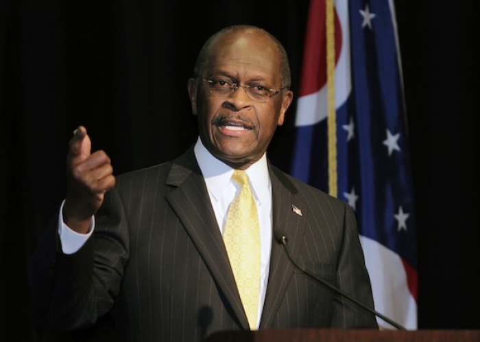 Republican presidential contender Herman Cain addresses campaign supporters during a campaign stop in Cincinnati, Ohio, November 30, 2011.