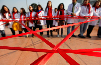 Medical students form a red ribbon, the symbol of the worldwide campaign against AIDS, during an HIV/AIDS awareness rally on World AIDS Day in central Istanbul December 1, 2011.