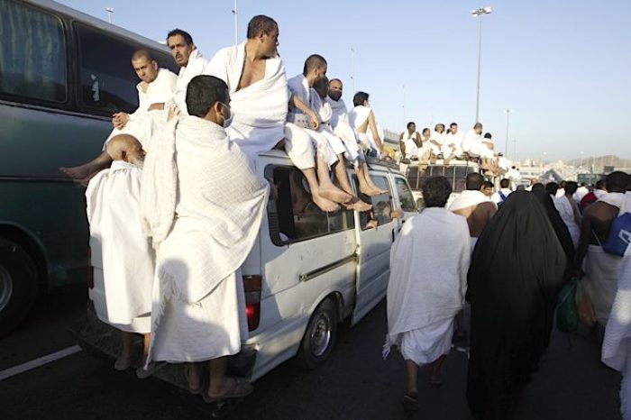 Muslim pilgrims arrive on a vehicle for prayers at Mena during the annual haj pilgrimage outside the holy city of Mecca on Nov. 6, 2011.