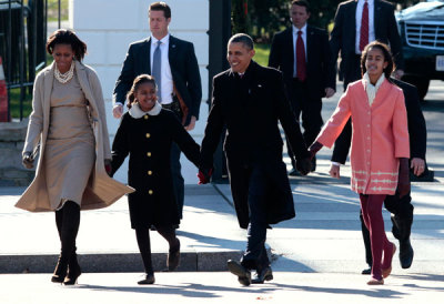 U.S. President Barack Obama with first lady Michelle Obama and their daughters Malia (R) and Sasha walk out from the White House to attend Sunday service at St. John's Episcopal Church in Washington December 11, 2011.