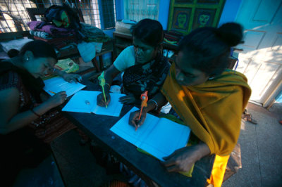Rehabilitated sex workers study during an educational programme run by a non-government organisation 'New Light' in the red light district of Kalighat in Kolkata January 4, 2008. Authorities in eastern India battling to curb human trafficking have now turned to sex workers for help as they step up their drive against the well organised, yet illicit trade.