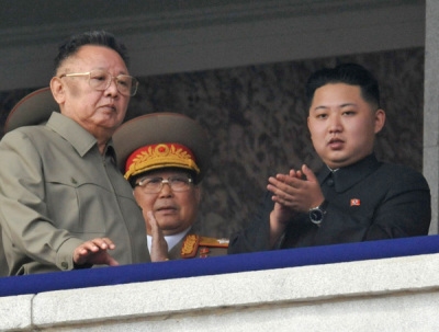 North Korean leader Kim Jong-il (L) walks in front of his youngest son Kim Jong-un (R) as they watch a parade in Pyongyang October 10, 2010.