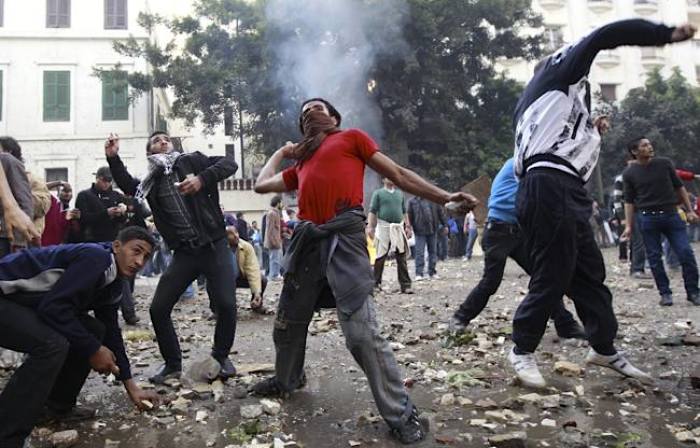 Protesters throw stones at army soldiers near Tahrir Square in Cairo, Egypt, on Dec. 16, 2011.