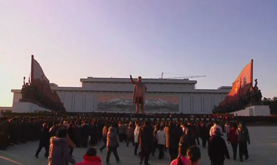 People walk near a statue of former North Korean President Kim Il-sung at a square on Mansu Hill in Pyongyang in this December 19, 2011 still image taken from video. North Korean leader Kim Jong-il, son of Kim il-sung, died on a train trip on Saturday, state television reported on Monday, sparking immediate concern over who is in control of the reclusive state and its nuclear programme.